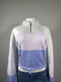 Y2K American Eagle colorblock quarter zip sweatshirt featuring soft fleece fabric in heather gray, lavender, and periwinkle blue. Finished with a mock neck, adjustable drawstring hem, and cropped silhouette for the perfect cozy Y2K look.