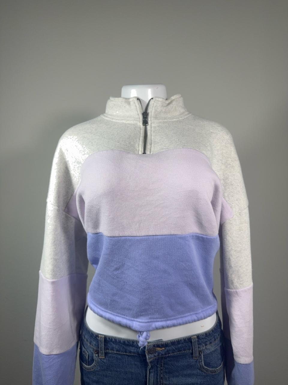 Y2K American Eagle colorblock quarter zip sweatshirt featuring soft fleece fabric in heather gray, lavender, and periwinkle blue. Finished with a mock neck, adjustable drawstring hem, and cropped silhouette for the perfect cozy Y2K look.