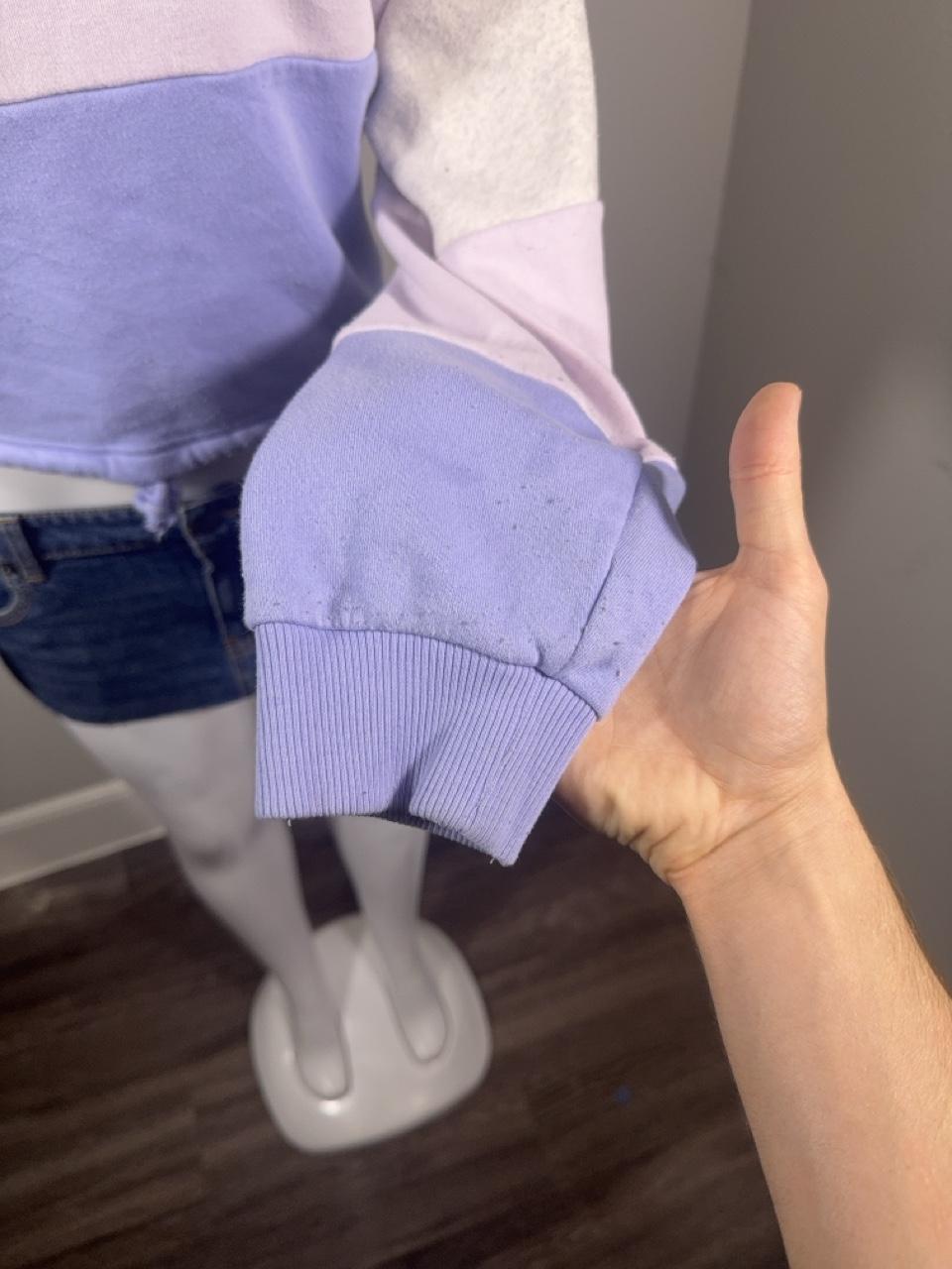 Y2K American Eagle colorblock quarter zip sweatshirt featuring soft fleece fabric in heather gray, lavender, and periwinkle blue. Finished with a mock neck, adjustable drawstring hem, and cropped silhouette for the perfect cozy Y2K look.