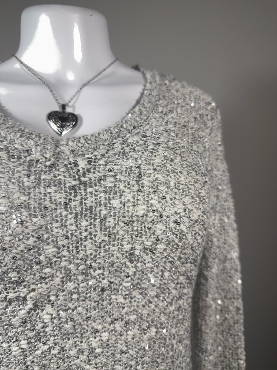 Y2K Apt. 9 silver sequin knit sweater featuring a soft marled knit with subtle shimmer throughout. A cozy yet elevated piece that's perfect for layering with jeans, skirts, or trousers for an effortless Y2K-inspired look.